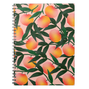 Carnet Peach motif sur arrière - plan rose. Fruit à main