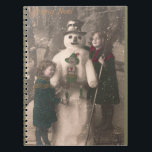 Carnet Photo de Christmas Girls et Snowman Vintage<br><div class="desc">A charming antique 1910 French Christmas photo postcard of two pretty,  adorable little girls happily hugging and posing with their solive snowman friend,  as snow flow down upon them. Wishing a Joyeux Noel.</div>