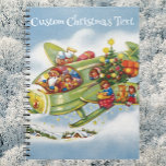 Carnet Vintage Christmas, Père Noël Avion<br><div class="desc">Illustration vintage Joyeux voyage de Noël et design de transport avec un joyeux Père Noël volant un avion à hélice à l'ancienne dans le ciel avec elfes, jouets, poupées, cadeaux emballés et un arbre de Noël sur l'aile. Ils survolent l'avion antique à travers les nuages blancs et les étoiles dans...</div>