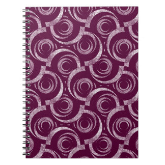 Carnet White ornament on a burgundy background.