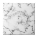 Carreau Carrelage gris et blanc, effet Marbre<br><div class="desc">Ce carrelage présente un design raffiné en marbre blanc mis en valeur par un doux voile gris. La motif en marbre naturel offre des détails subtils et un look propre et classique qui met en valeur les espaces modernes et traditionnels. Avec une finition lisse et brillante, le carrelage est durable...</div>