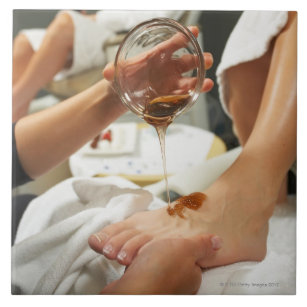 Carreau Femme recevant le massage de pied avec de l'huile