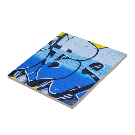 Carreau Graffiti bleu sur un mur de briques (Côté)