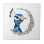 Carreau Lune de parties scintillantes d'argent de paon<br><div class="desc">C'est une peinture d'aquarelle d'un paon. L'oiseau a de belles couleurs de mélange de bleu et de vert. L'oiseau regarde très noble et fier. Il y a le cercle argenté de parties scintillantes de faux autour de l'oiseau.</div>