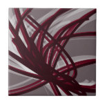 Carreau Rubans Abstraits gris et bordeaux<br><div class="desc">Design artistique moderne avec des rubans bordeaux aux accents blancs sur un arrière - plan gris. Conçu avec des graphiques vectoriels, vous pouvez créer votre propre oreiller customisé en changeant les couleurs arrière - plan et bordure. Pour créer votre design personnalisé, sélectionnez "customiser" et accédez à la section calques pour...</div>