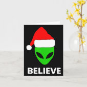 Carte Alien Green Face Christmas Santa Hat Believe  (Fleur jaune)