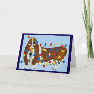 Carte Basset Hound empêtré dans les lumières de Noël