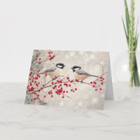Béliers et baies rouges avec des flocons de neige