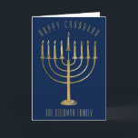 Carte bleue de Hanukah<br><div class="desc">Send your loved ones a personalized card this Chanukah season. This design feesta gold colored menorah on a navy blue background. Above it the message reads "Happy Chanukah". Below the menorah is a place for your family name which you may personalize or remove if you'd like. "Wishing you peace, love,...</div>