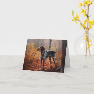 Carte Bluetick Coonhound dans les feuilles d'automne qui