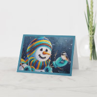 Bonhomme de neige d'hiver nourrit un mésange oisea