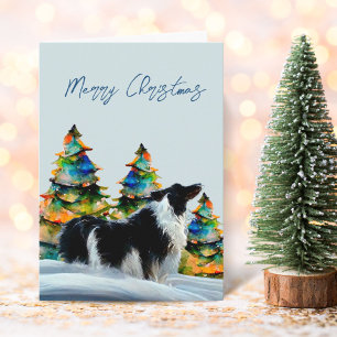 Carte Border Collie dans l'arbre de Noël sous la neige d