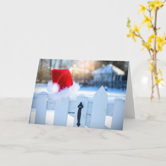 Carte Chapeau de Père Noël sur une clôture blanche à pic (Fleur jaune)