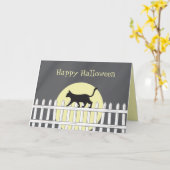 Carte Chat noir effrayant sur une clôture à piquets (Fleur jaune)