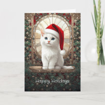 Chaton blanc avec chapeau de Père Noël pour les fê
