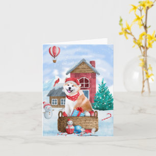 Carte Chien Akita dans la maison de Noël enneigée