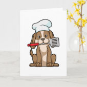 Carte Chien comme cuisinier avec toque et spatule (Fleur jaune)