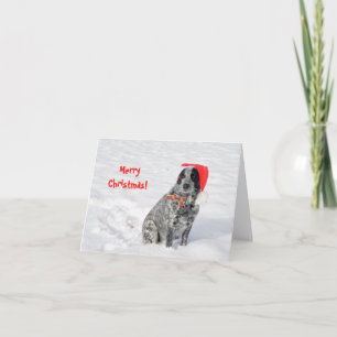 Carte Chien dans la neige avec un chapeau de Père Noël e