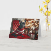 Carte Chien de taureau noir de Noël sur une chaise rouge (Fleur jaune)