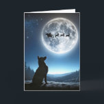 Carte Chien observant le Père Noël et Reindeer<br><div class="desc">Un chien berger allemand regarde vers la pleine lune où le traîneau à Père Noël et les rennes sont silhoués contre une pleine lune brillante</div>