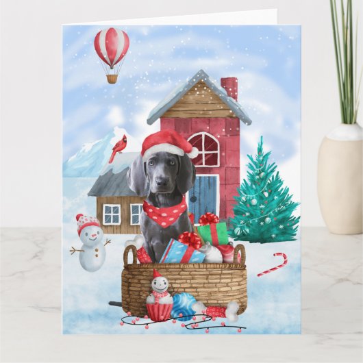 Carte Chien Weimaraner dans une maison de Noël enneigée (Devant)