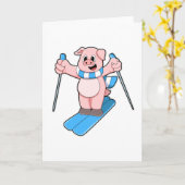 Carte Cochon skieur avec écharpe de ski et bâtons de ski (Fleur jaune)
