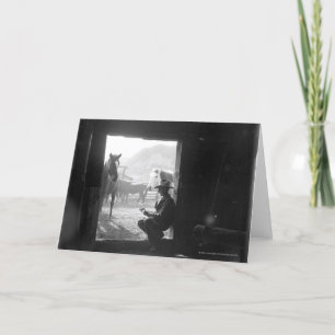 Carte Cowboy dans une porte avec des chevaux