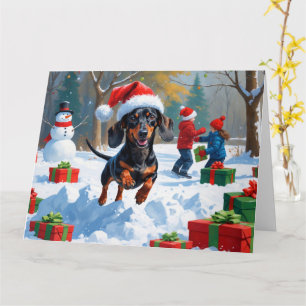 Carte Dachshund courant dans la neige avec un chapeau de