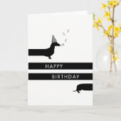 Carte Dachshund drôle avec casquette de fête Joyeux anni (Fleur jaune)