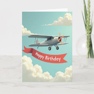 Carte d'anniversaire biplan dans le ciel