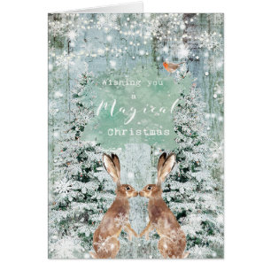 Carte de lièvres de neige d'hiver de Joyeux Noël