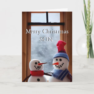 Carte de Noël mignonne de papa et fils dans la nei