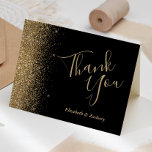 Carte de remerciements de Mariage noir Gold Partie<br><div class="desc">Cette élégante carte de remerciements mariage moderne est ornée d'une bordure de parties scintillant en faux or sur un arrière - plan noir. Le texte personnalisable combine les mots "Merci" en écriture manuscrite couleur or pâle et les noms de la mariée et du marié en caractères italiques.</div>