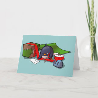 Carte de voeux de pingouin d'enveloppement actuel