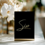 Carte De Vœux En Aluminium Elegant Black & Gold Foil Wedding Table Number<br><div class="desc">Add a touch of modern luxury to your wedding reception with this minimalist arched table number, featuring an elegant gold foil look script on clear acrylic. The design mimics real foil with a subtle printed shimmer, offering an upscale effect without the cost. Perfect for modern, chic, or romantic wedding themes....</div>