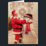 Carte de voeux père Noël & Snowman<br><div class="desc">Ho Ho Ho ! C'est l'heure de Noël et Père Noël construit un bonhomme de neige. Un regard nostalgique sur cette fantastique image de vacances. Sur la carte on peut lire "Joyeux Noël !"</div>