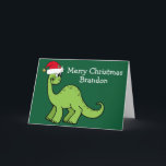 Carte Dinosaure de Noël mignon à Santa Hat Custom Green<br><div class="desc">Dinosaure vert magnifique souriant et très mignon dans un chapeau de Noël rouge vacances. Les enfants adoreront cette carte de vacances verte cool. Customisez ces cartes de Noël avec votre propre texte en blanc.</div>