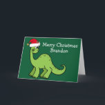 Carte Dinosaure de Noël mignon à Santa Hat Custom Green<br><div class="desc">Dinosaure vert magnifique souriant et très mignon dans un chapeau de Noël rouge vacances. Les enfants adoreront cette carte de vacances verte cool. Customisez ces cartes de Noël avec votre propre texte en blanc.</div>