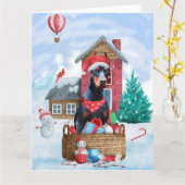 Carte Doberman dans une maison de Noël enneigée pour chi (Fleur jaune)