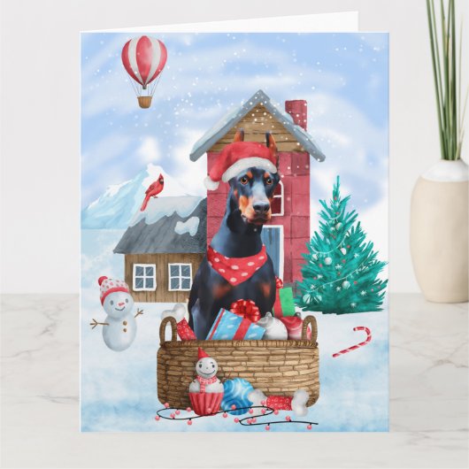 Carte Doberman dans une maison de Noël enneigée pour chi (Devant)
