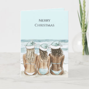 Carte Femmes avec chapeaux de Père Noël sur la plage de