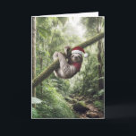 Carte Fente De Noël Dans Rainforest<br><div class="desc">Un paresseux portant un chapeau de Père Noël rouge et blanc et un foulard rouge est suspendu confortablement à une branche au milieu d'une forêt verdoyante</div>