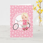 Carte Fille blonde sur bicyclette - Rose Blanc (Fleur jaune)