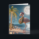 Carte Flamant rose de Noël portant un chapeau de Père No<br><div class="desc">Un flamant festif portant un chapeau de Père Noël et une couronne se dresse sur une plage tropicale sous une pleine lune Tout le texte peut être changé.</div>