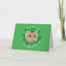 Joli hamster de la Saint-Patrick regardant à trave