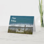 Carte Joyeux anniversaire Brother-Ocean Waves<br><div class="desc">C'est une belle carte pour l'anniversaire de votre frère, avec une vue sur les vagues bleues de l'océan, vue à travers une clôture avec du gazon de plage agitant dans le vent. A l'intérieur est un joli verset que vous pouvez bien sûr customiser/personnaliser pour répondre à vos besoins! Vous pouvez...</div>