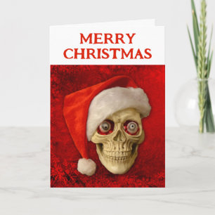 Carte Joyeux Noël. Crâne portant un chapeau de Père Noël