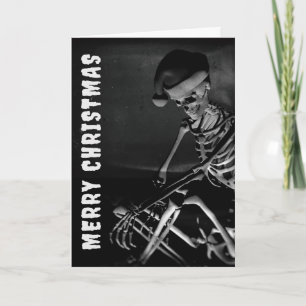 Carte Joyeux Noël. Squelette avec chapeau de Père Noël