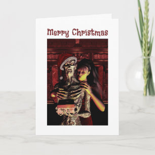 Carte Joyeux Noël. Squelette drôle avec femme
