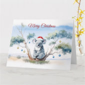 Carte Koala assis dans un eucalyptus Joyeux Noël (Fleur jaune)